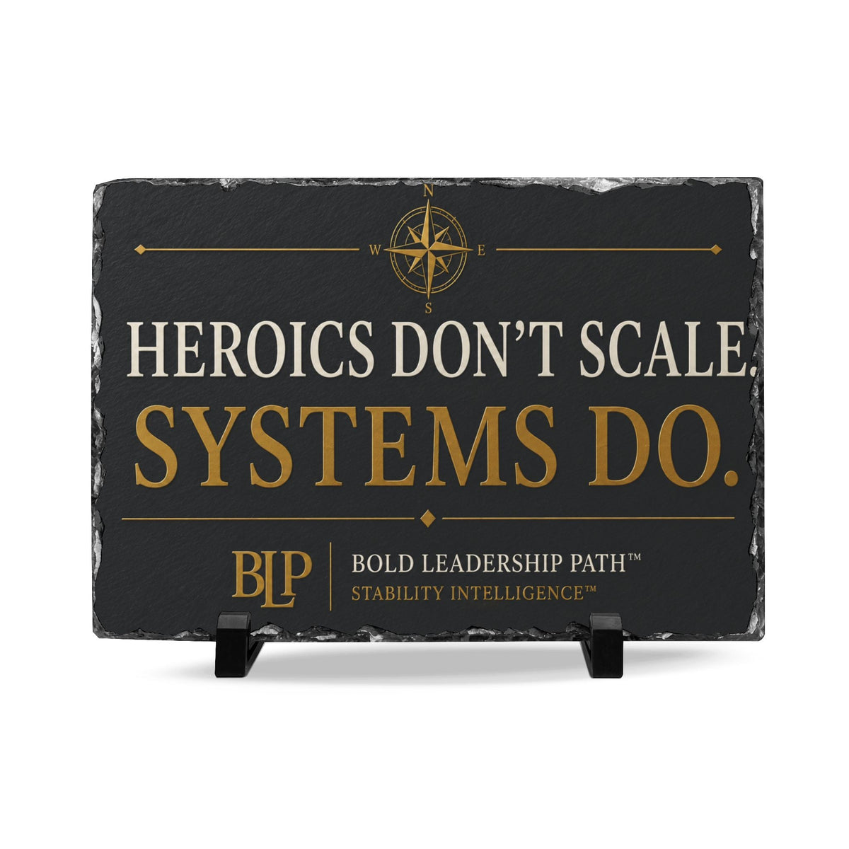 Slate plaque reading “Heroics Don’t Scale. Systems Do.” from the Stability Intelligence™ series