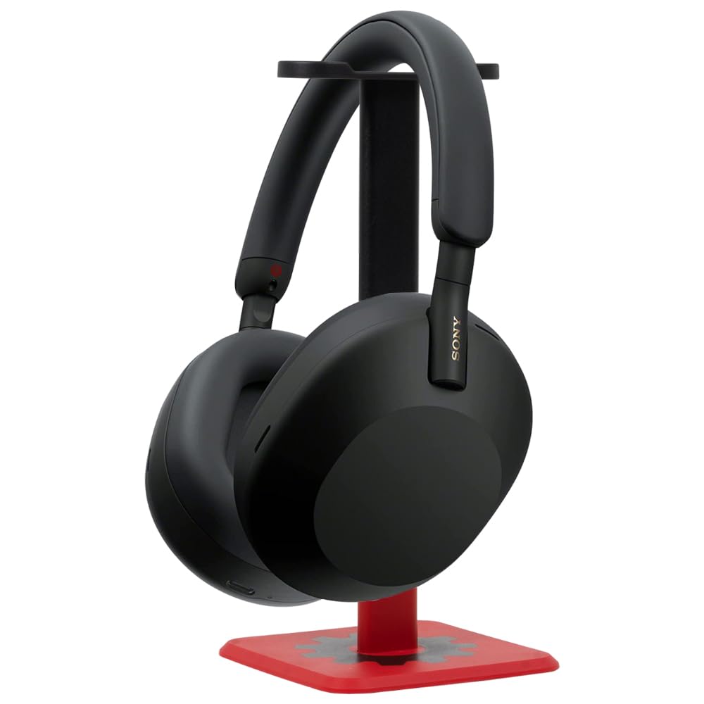 Premium black Sony WH-1000XM5 noise-canceling headphones resting on a minimalist matte black stand against a dark, textured background. Features the Bold Leadership Path logo in gold.
