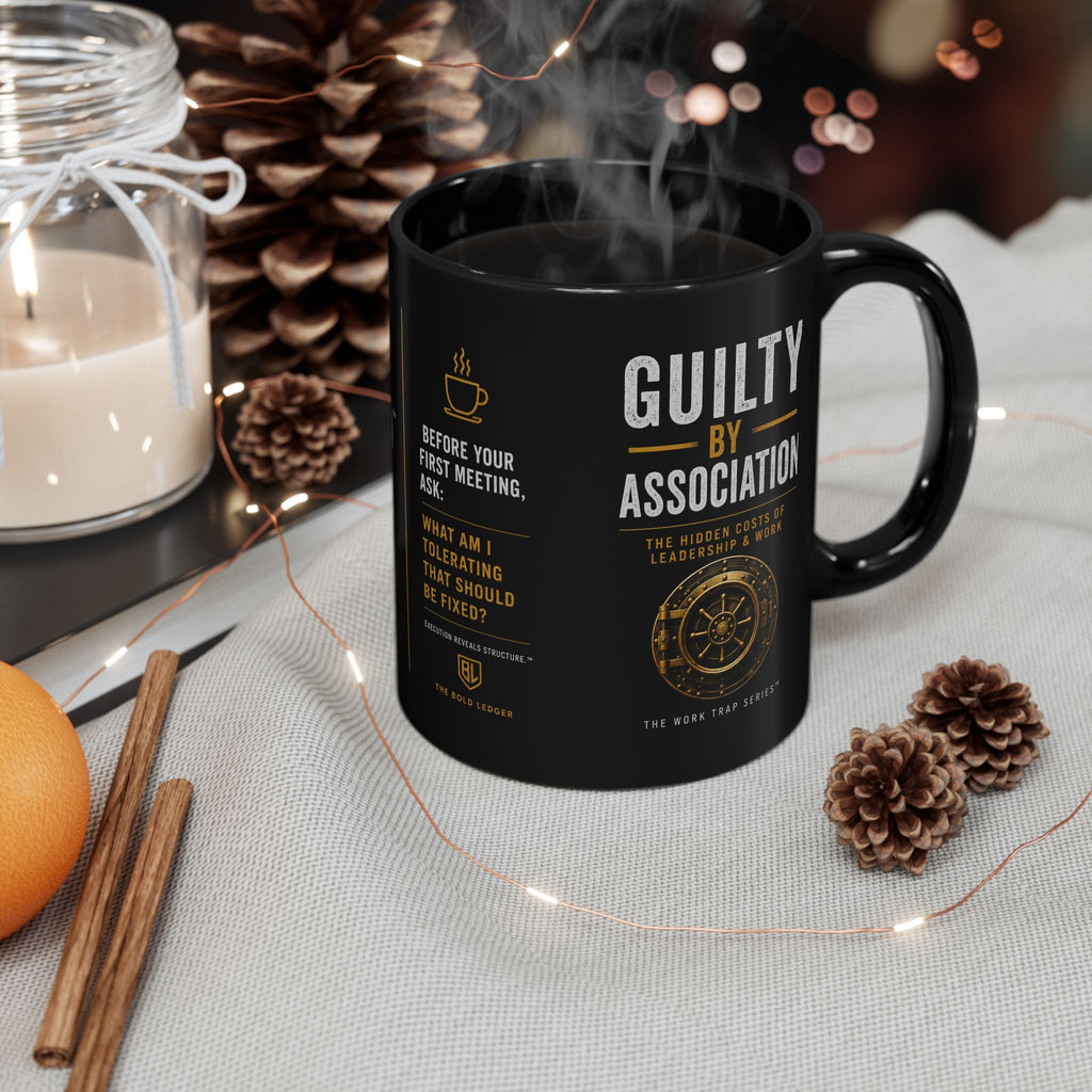 Black mug with text on a table with decorative items