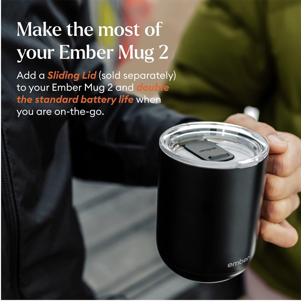  A matte black Ember Smart Mug 2 with a glowing white LED indicator at the base, sitting on a neutral grey surface. Features the Bold Leadership Path logo.