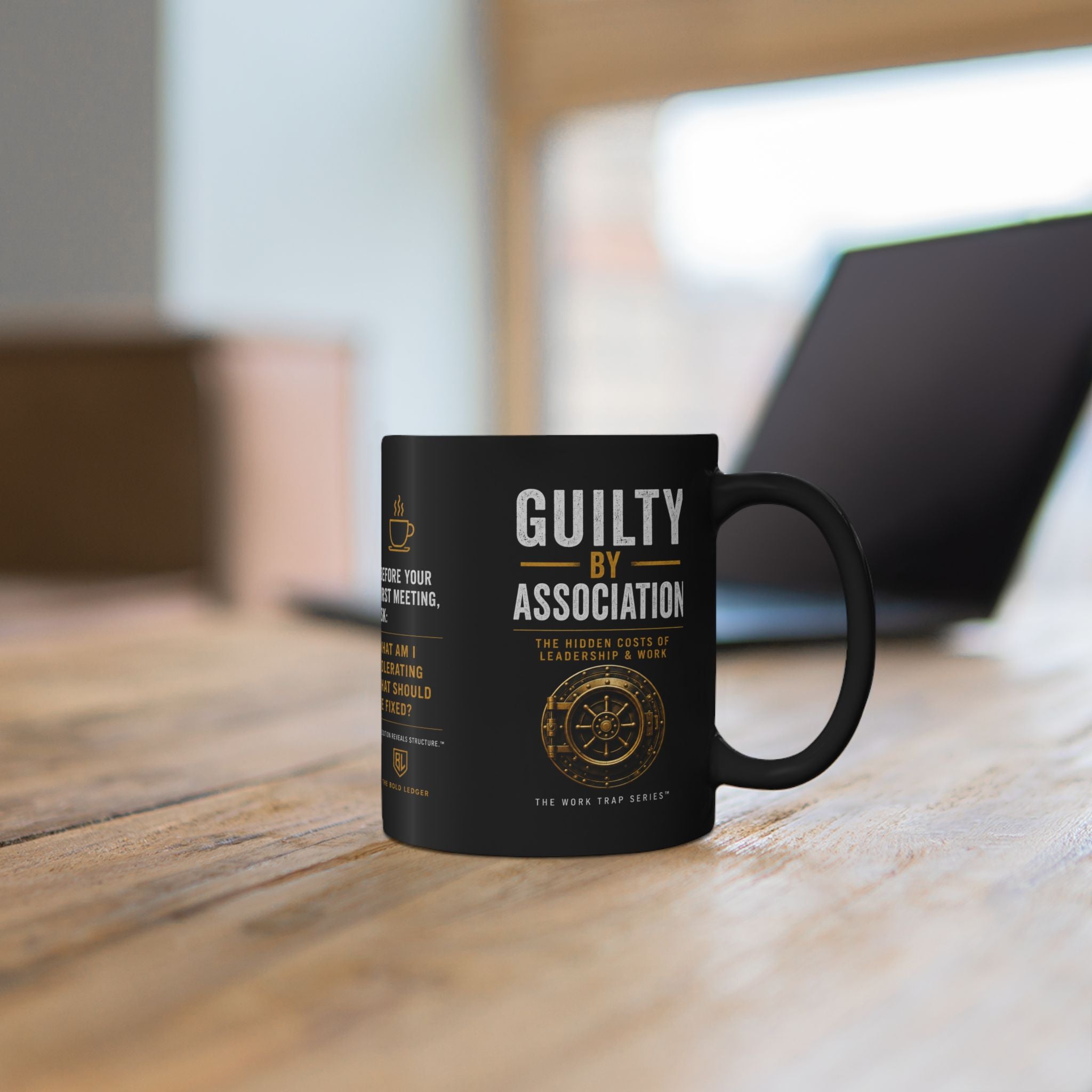 Black mug with a design on a wooden surface